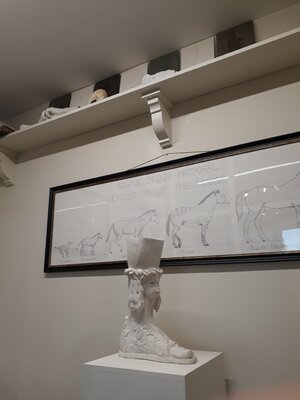 Barry Davies RCA in de studio: A classical sculpture and a drawing of a proposed statue design of horse evolution.