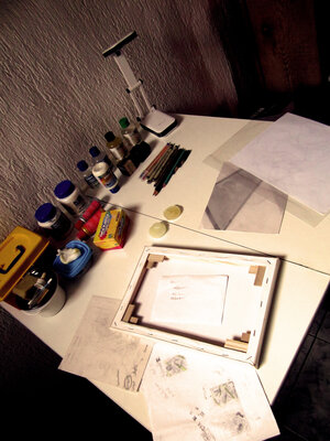 Rodrigo Silva en el estudio: Current view on drawing table. Simple straight table with drawing in progress, sketches, a small canvas, etc