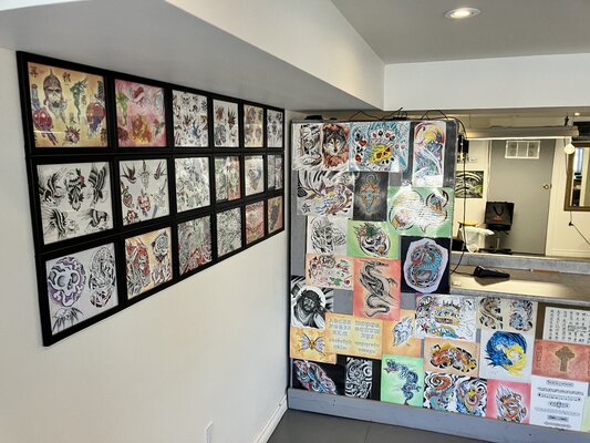 David Coulson dans le studio: A view from the front door as you enter the tattoo studio with tattoo designs my wife and I have drawn up.  Some classics, some originals.