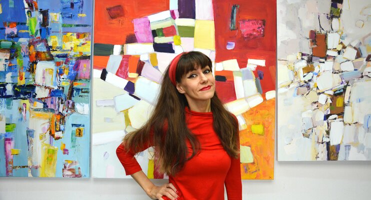 Iryna Kastsova im Studio: Photo in the studio. Against the background of abstract works.