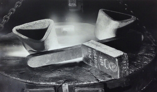 Newly stamped bar of gold resting on lip at a melting furnace at the US Assay Office, New York City par Margaret Bourke-White, Photographie en vente sur Singulart