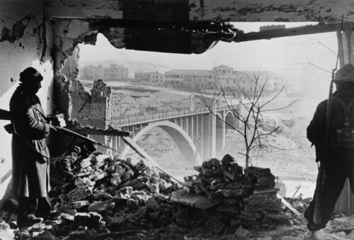 Spain, Aragon front, Battle of Teruel, Republican soldiers inside the Governor's Palace, the last bastion of the Fascist resistance. Earlier that day the Republicans had detonated mines powerful enough to blow away an entire wall van Robert Capa, Fotografie te koop op Singulart