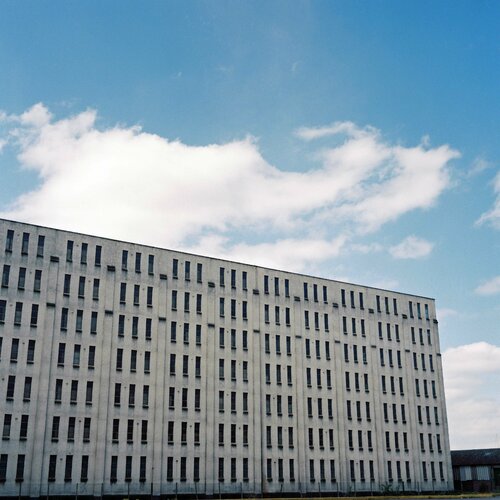 Clouds above warehouse di John Brooks, Fotografia in vendita su Singulart