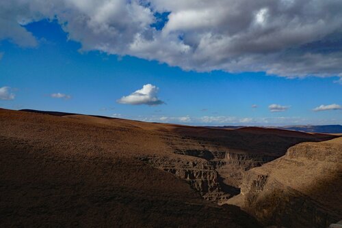 Ravine with sunlight and clouds John Brooks