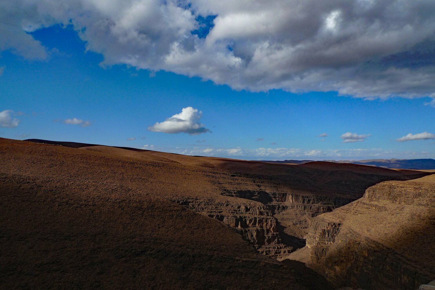 Ravine with sunlight and clouds John Brooks