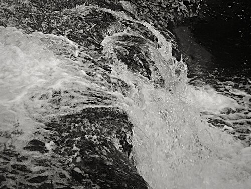 Dynamic Water Flows Gracefully Over Rocky Terrain, Capturing Nature's Raw Energy di Karlton McIver, Fotografia in vendita su Singulart