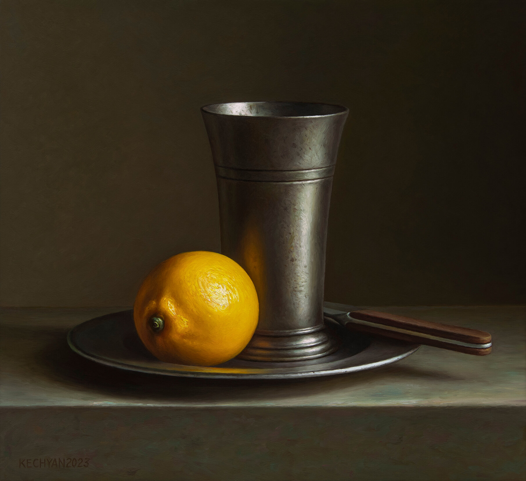 Lemon with a pewter beaker